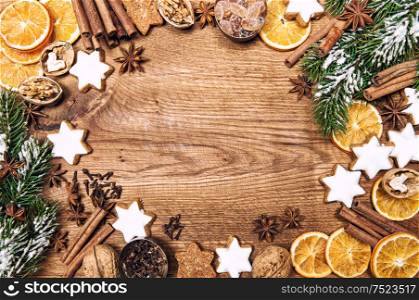 Christmas decorations, cookies and spices. Holidays food ingredients on rustic wooden background