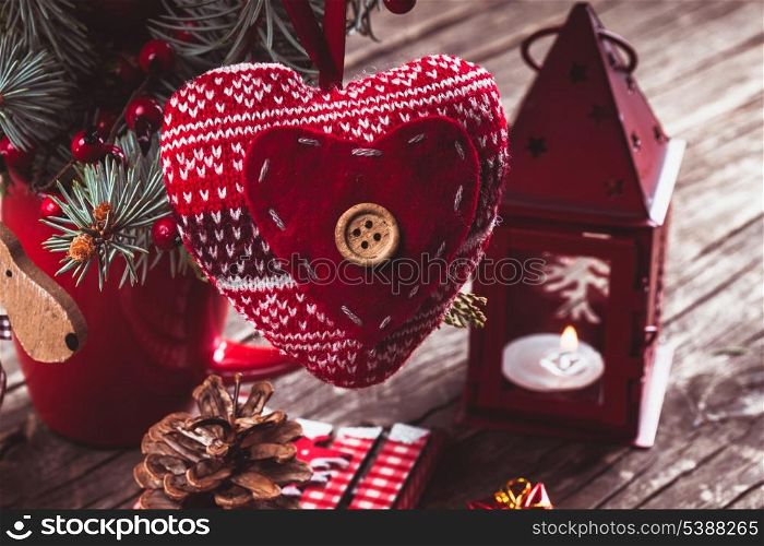 Christmas decorations: heart, candlestick and sleds on old wooden table