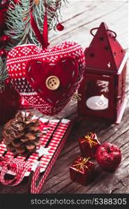 Christmas decorations: heart, candlestick and sleds on old wooden table