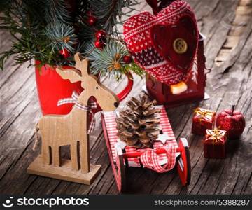 Christmas decorations: heart, deer and sleds on old wooden table