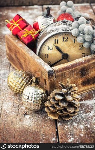 Christmas decorations. Old clock in wooden box lined with Christmas decorations
