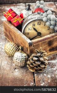 Christmas decorations. Old clock in wooden box lined with Christmas decorations