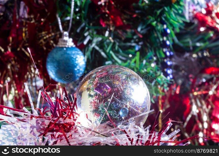 Christmas decorations on a tree through lens ball, macro shot close-up