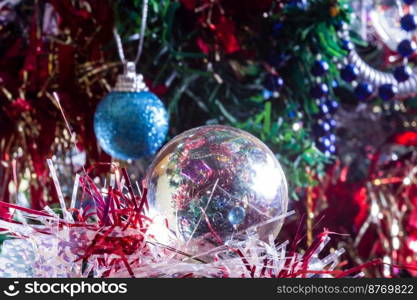 Christmas decorations on a tree through lens ball, macro shot close-up