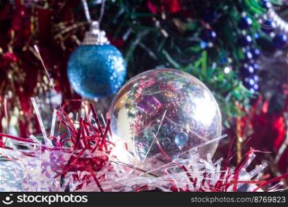 Christmas decorations on a tree through lens ball, macro shot close-up