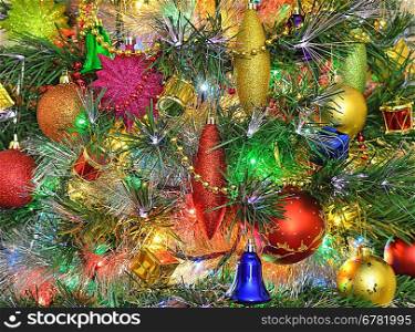Christmas decorations on Christmas tree against festive illuminations