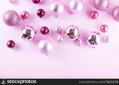 Christmas decorations on pink background, top view. Christmas decorations on pink