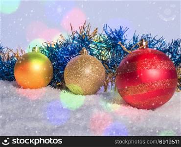Christmas decorations on the snow. Falling snow and bokeh