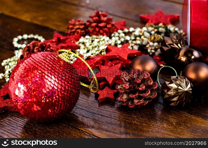 Christmas decorations on wooden board. Colorful, gliterry and shiny Christmas decorations.