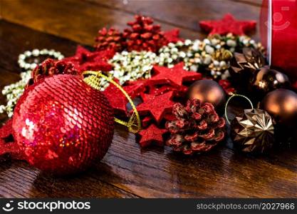 Christmas decorations on wooden board. Colorful, gliterry and shiny Christmas decorations.