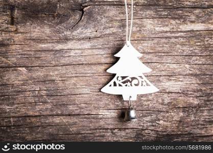 Christmas decorations - white wooden fir tree over shappy old background