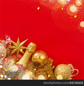 christmas decorations with bottle of champagne on red background, flat lay csene with copy space. christmas decorations with bottle of champagne