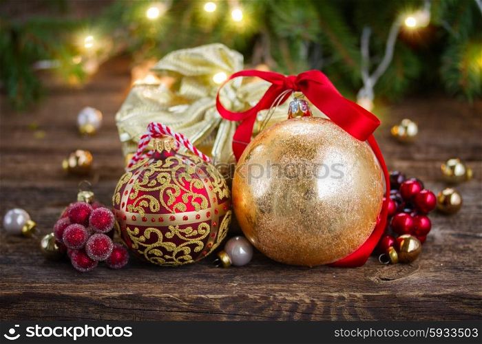 christmas decorations with gift box. golden christmas balls and gift box with defocused christmas lights in background