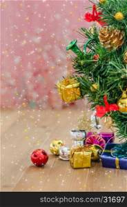 Christmas decorations with snow. Christmas background with decorations and gift boxes on wooden board