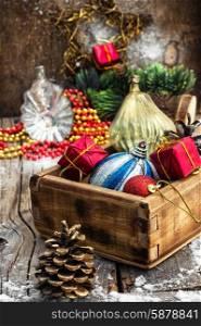 Christmas decorations. Wooden box filled with old fashion Christmas decorations.Photo tinted.