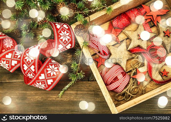 Christmas decorations wooden stars and red ribbons. Vintage style toned with lights effect