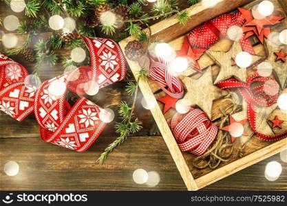 Christmas decorations wooden stars and red ribbons. Vintage style toned with lights effect