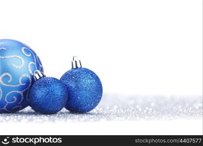Christmas decorative balls on shiny silver background