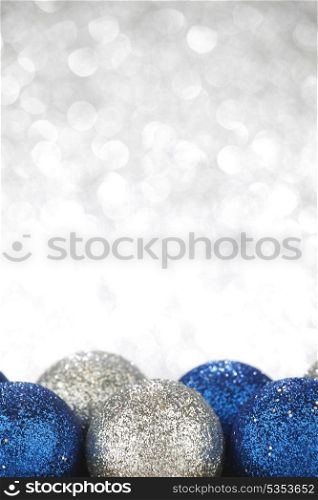 Christmas decorative balls on shiny silver background