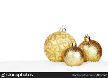 Christmas decorative balls on snow close-up