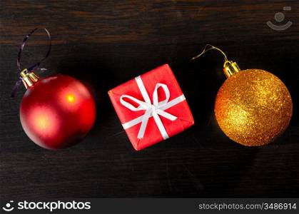 christmas decorative objects, top view of gift box with golden and red ball