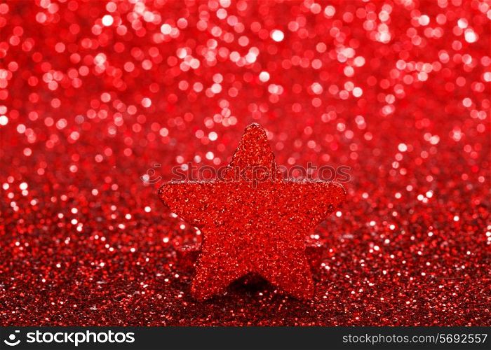 Christmas decorative red star on shiny glitters background