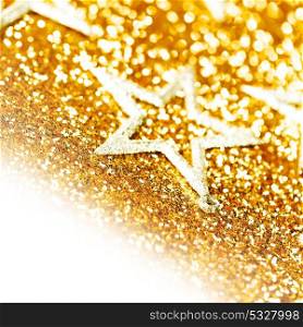 Christmas decorative stars on shiny glitters golden background