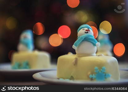 Christmas dessert with snowman. Christmas dessert with snowman on lights bokeh background