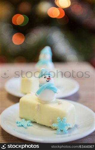 Christmas dessert with snowman. Christmas dessert with snowman on lights bokeh background