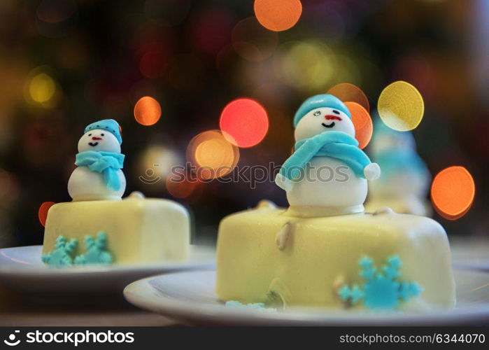 Christmas dessert with snowman. Christmas dessert with snowman on lights bokeh background