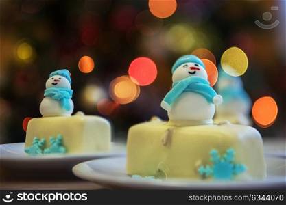 Christmas dessert with snowman. Christmas dessert with snowman on lights bokeh background