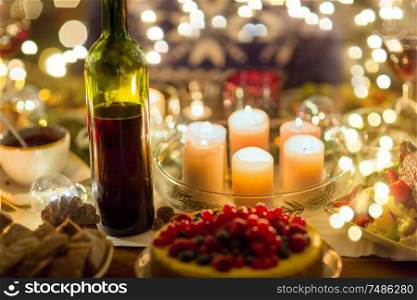 christmas dinner and decoration concept - food, drinks and candles burning on table. food, drinks and candles burning on table
