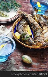 Christmas dish of roasted fish. Fried fish stuffed with lemon and spices at the Christmas table