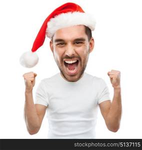 christmas, emotions and people concept - young man in santa hat celebrating victory and screaming over white background (funny cartoon style character with big head). screaming man in santa hat celebrating victory