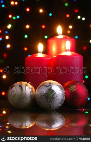 Christmas evening. A composition from candles, New Year&rsquo;s toys on a dark background