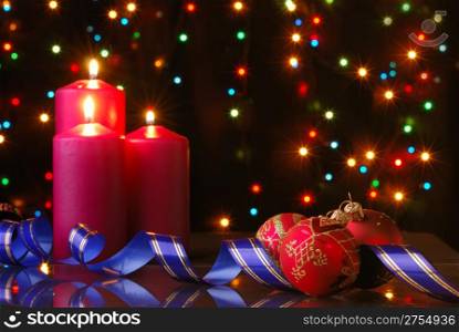 Christmas evening. A composition from candles, New Year&rsquo;s toys on a dark background