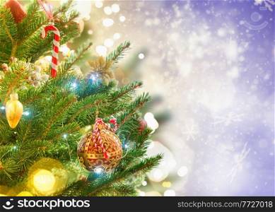 christmas evergreen fresh tree with holiday decorations and lights with copy space on magic bokeh background, toned. christmas fir tree with decorations