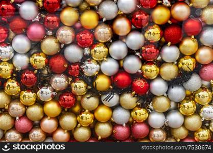 Christmas festive decorations, shining top view background. Gray Christmas decorations on pink