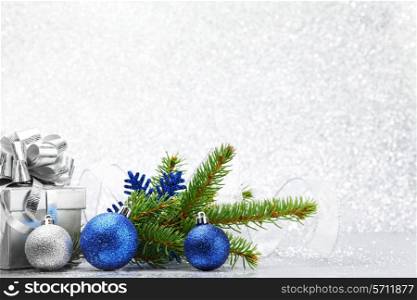 Christmas fir branch and decoration on abstract silver background
