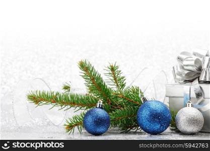 Christmas fir branch and decoration on abstract silver background