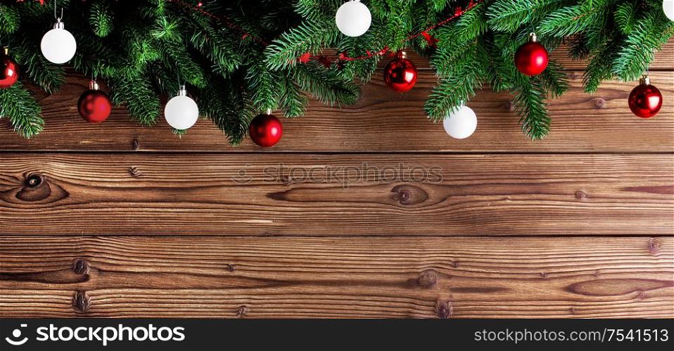 Christmas fir tree and decorative baubles on wooden background. Christmas fir tree and decor