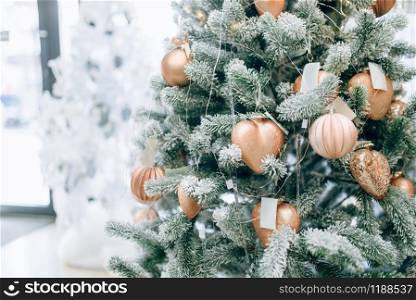 Christmas fir tree decorated with golden toys closeup view, nobody. Xmas holiday celebration symbol, bauble decoration