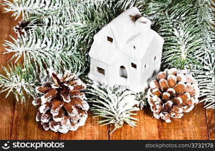 Christmas fir tree, house on wooden background