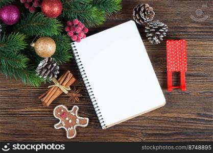 Christmas fir tree with decoration and empty note on brown wooden board. Christmas and New Year background