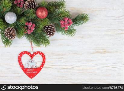 Christmas fir tree with decoration on white wooden board. Christmas fir branch with decoration