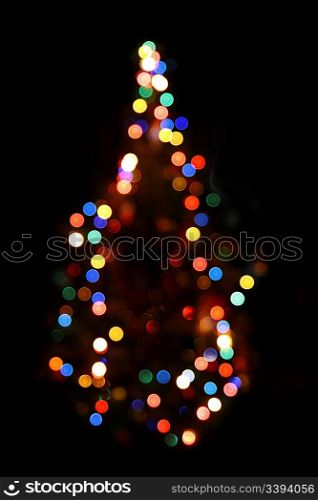 christmas fir with defocused colored lightings at night