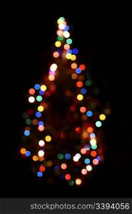 christmas fir with defocused colored lightings at night
