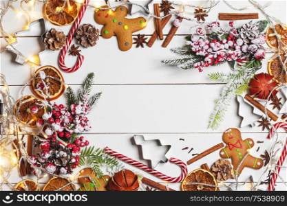Christmas flat lay background with traditional gingerbread cookies dried orange cinnamon on wood , copy space for text. Christmas food on wood background