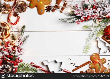 Christmas flat lay background with traditional gingerbread cookies dried orange cinnamon on wood , copy space for text. Christmas food on wood background