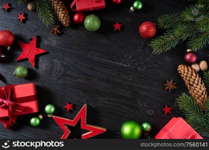 Christmas flat lay frame with red git boxes, Christmas celebration and gift giving concept, copy space on wooden background. Christmas flat lay scene with golden decorations